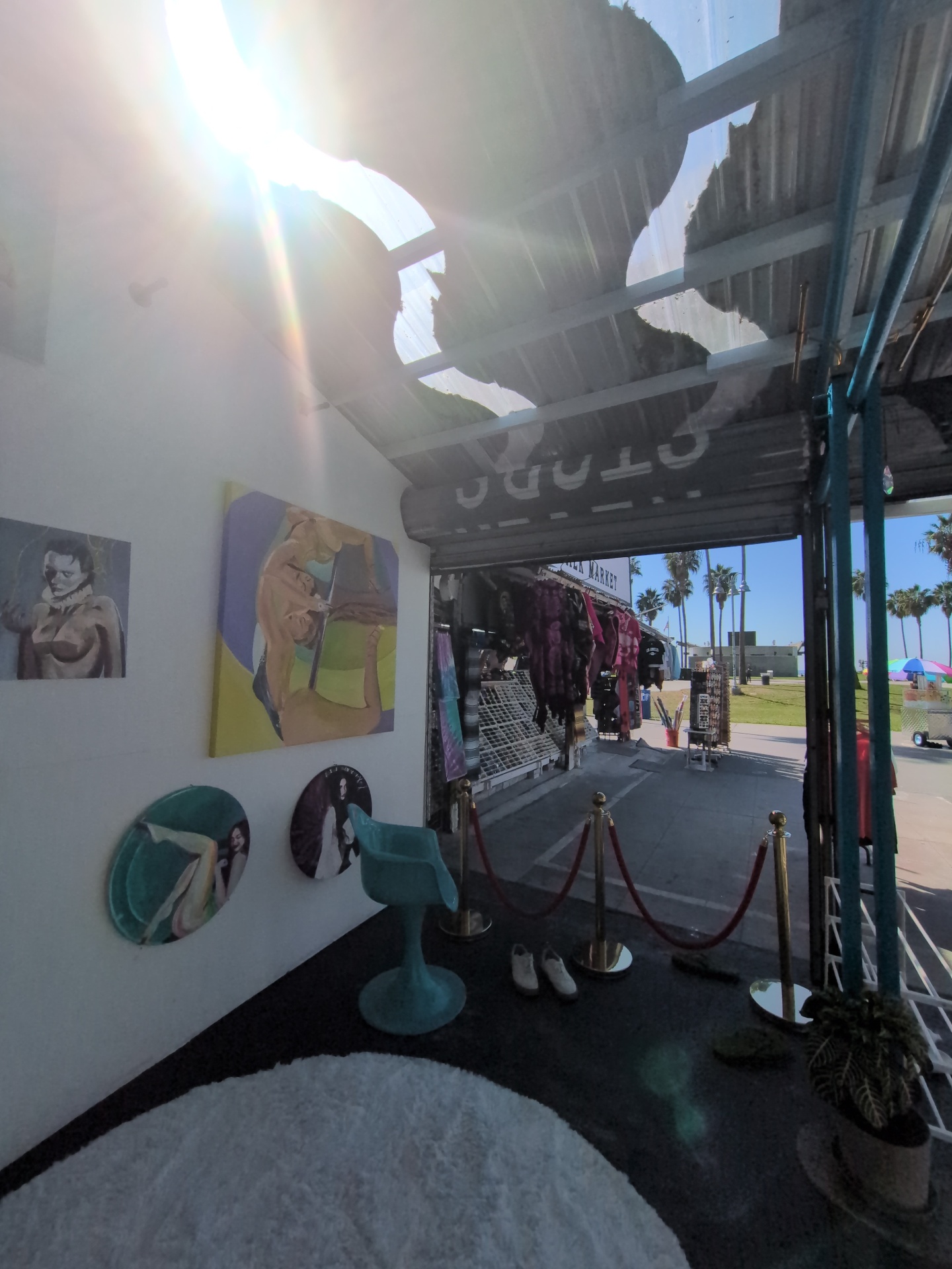 The Front Wall — Paintings by Evan Moore beside the roll-up door